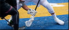 Opposing lacrosse players facing off.