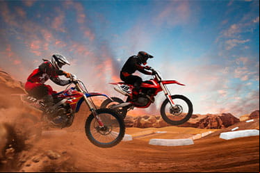 Dirtbike riders racing in a supercross event.