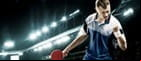 A table tennis player hitting a ball.