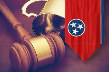 A judges gavel and hammer behind the Tennessee state flag.